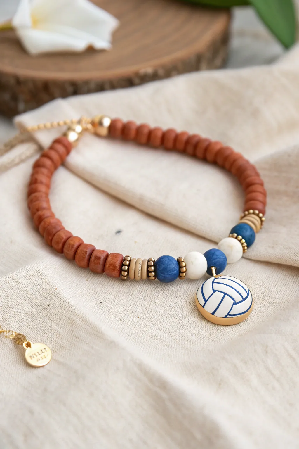 Minimal clay heishi volleyball bracelet with a keepsake tag bead for tournament-day memories.