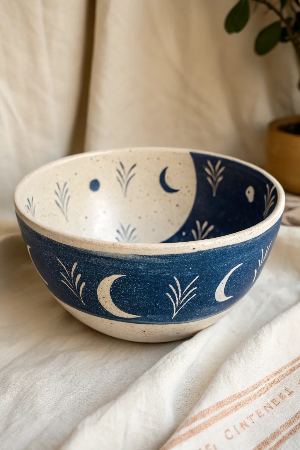 Deep indigo paint meets crisp negative space shapes for a modern, minimal bowl design.