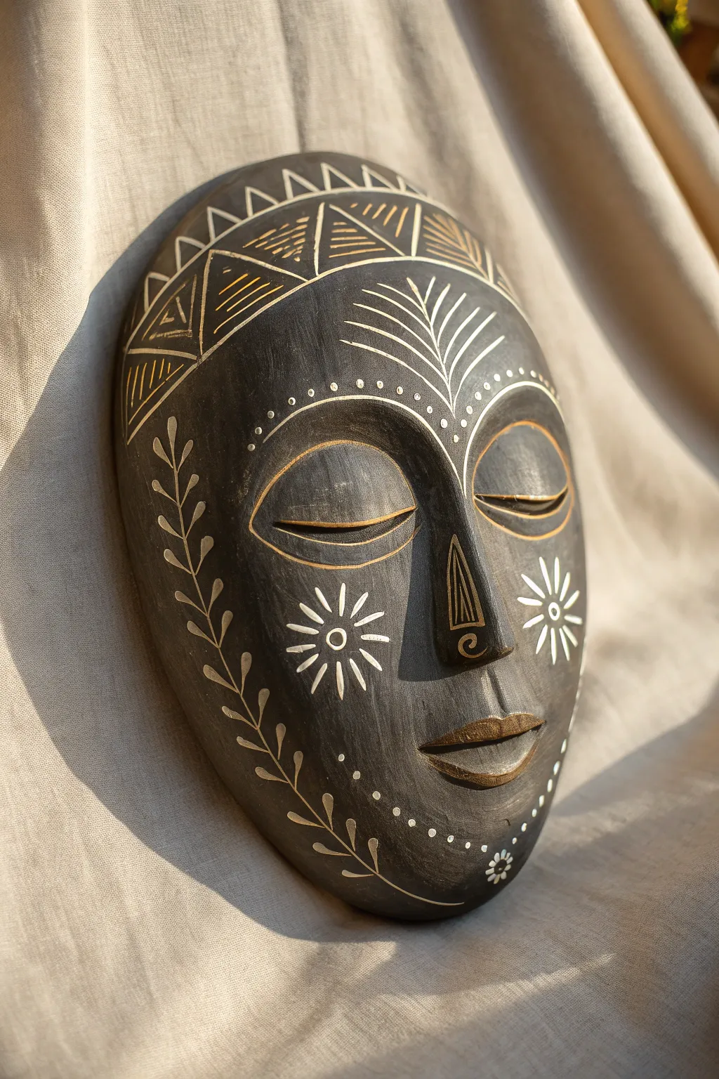Minimalist sgraffito portrait mask with bold contrast and warm clay tones, calm boho vibe
