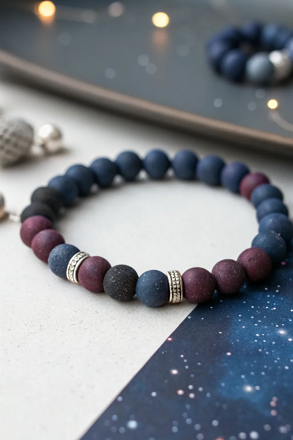 Moody night sky clay bead bracelet in navy, charcoal and deep purple with a soft silver glow