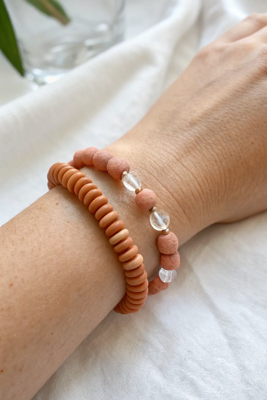 Minimal negative space bracelet: clay disc beads with clear spacers for an airy look.