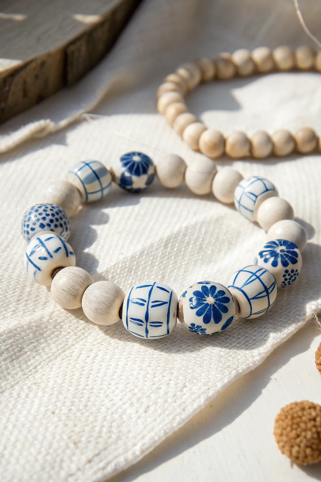 Tile-inspired blue-and-white clay bead bracelet with minimalist Scandinavian-boho charm