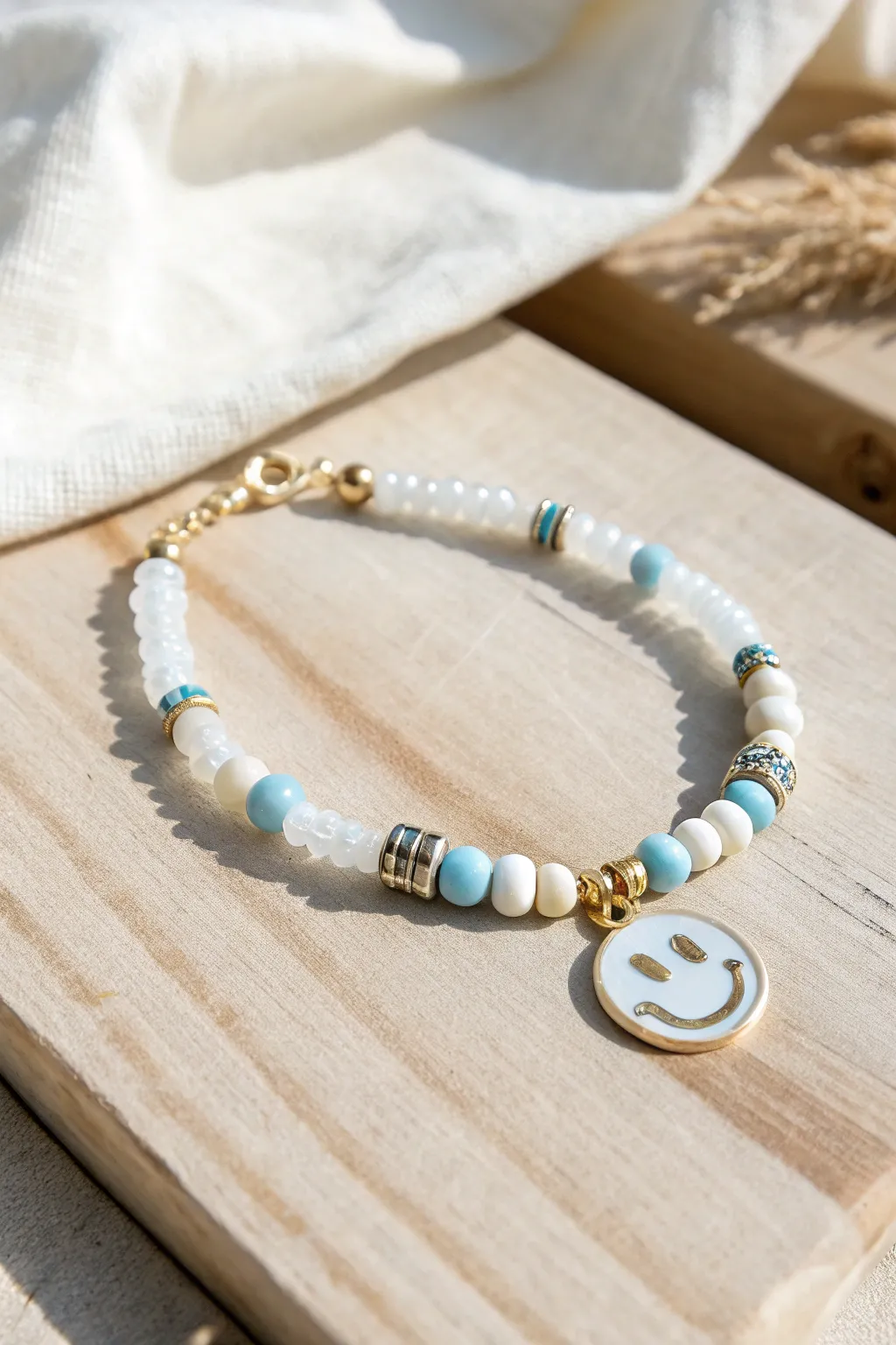 Airy heishi beads and a translucent smiley centerpiece for a fresh, minimalist boho bracelet.