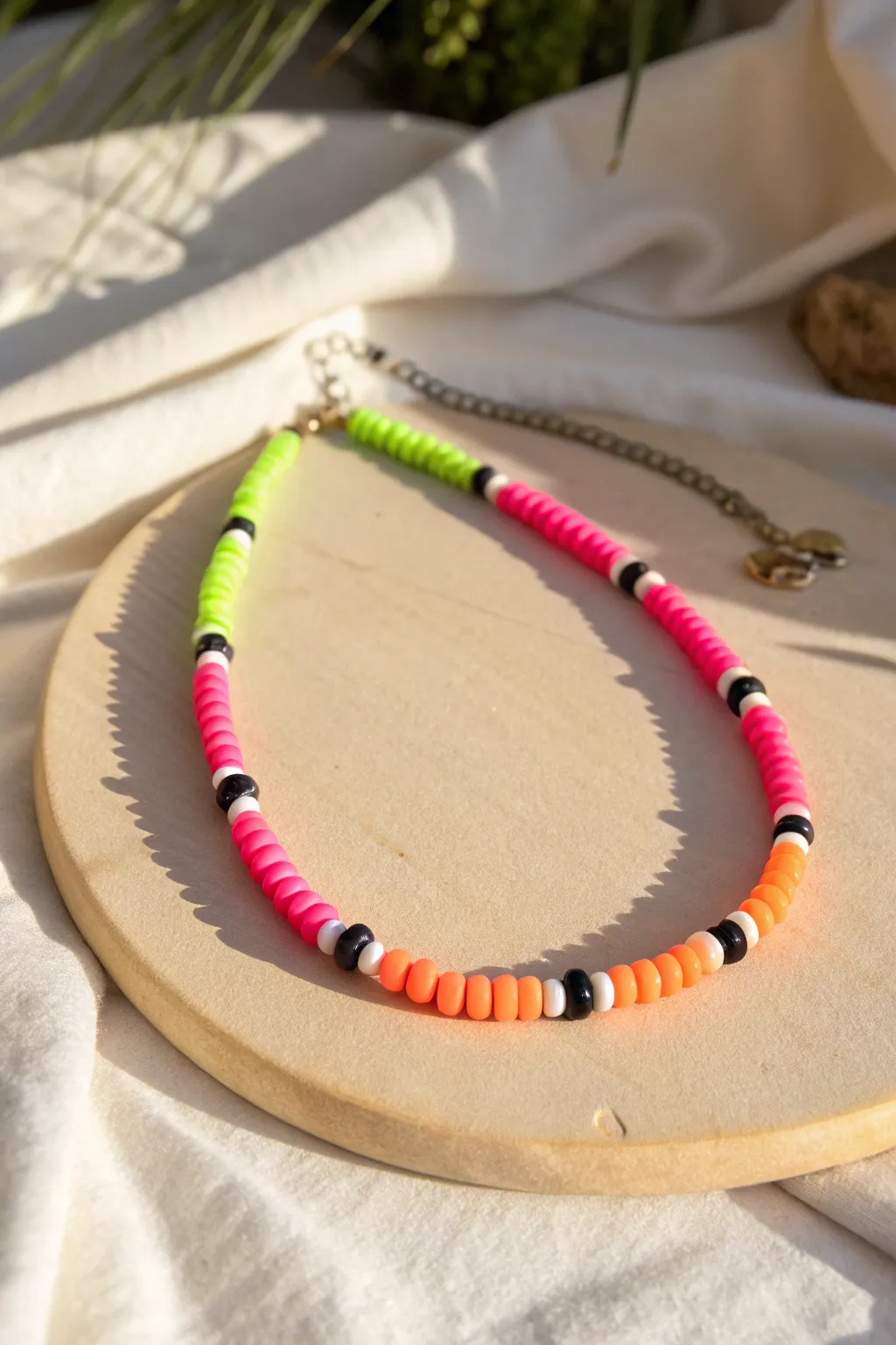 Unexpected neon heishi necklace for summer nights, minimalist styling with bold color pop