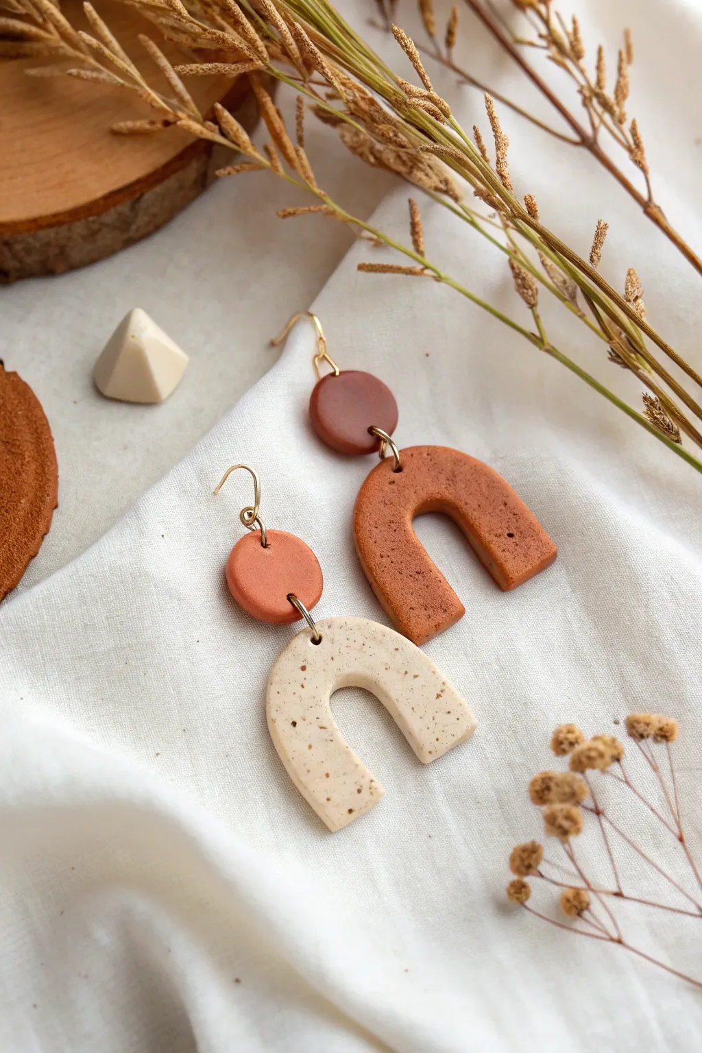 Mismatch clay earrings, one palette and two shapes for a balanced, minimalist statement set.