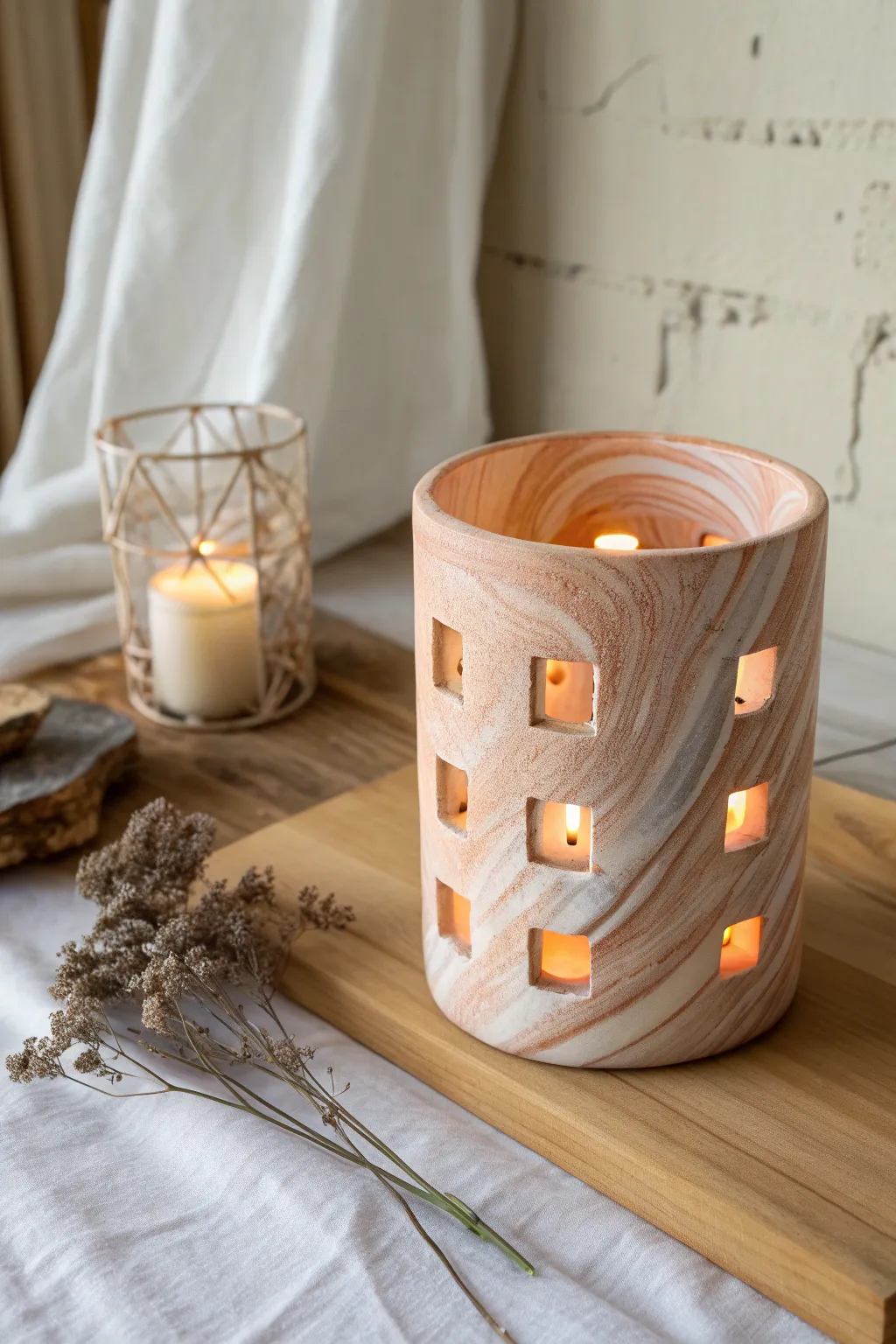 Marbled two-tone clay luminary with simple geometric windows and a warm, cozy glow.