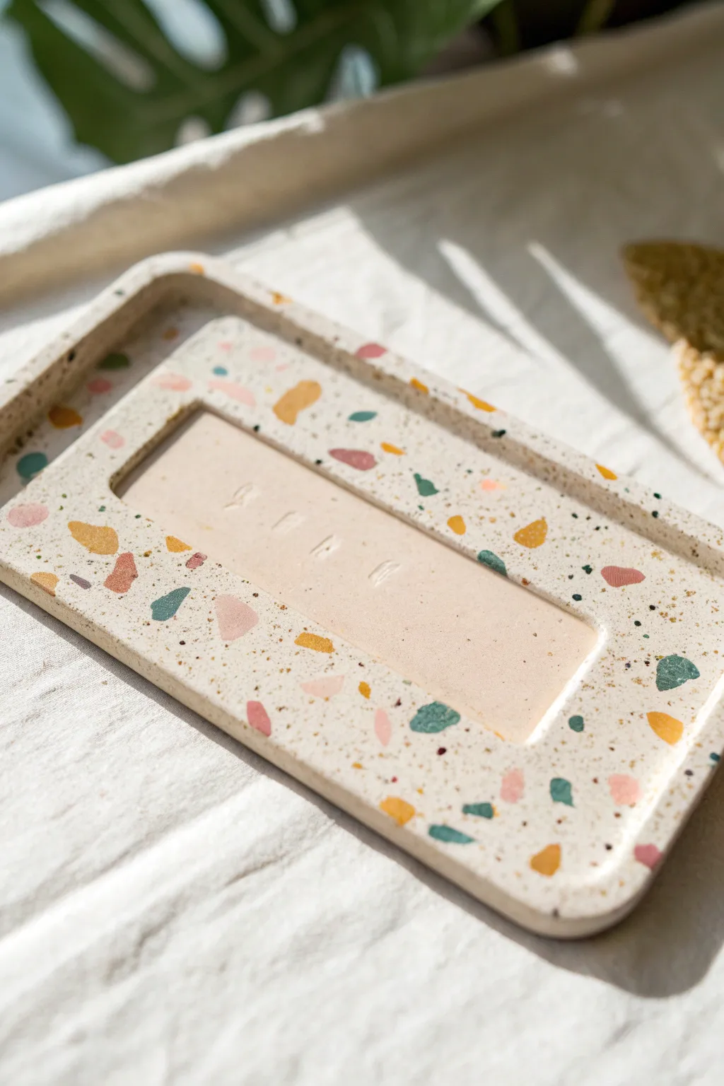 Terrazzo speckled clay name plate in soft pastels, minimalist and handmade, Pinterest ready.