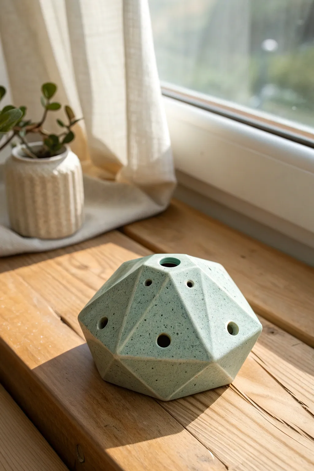 Faceted geometric ocarina in satin glaze, a minimalist boho accent with crisp modern edges.