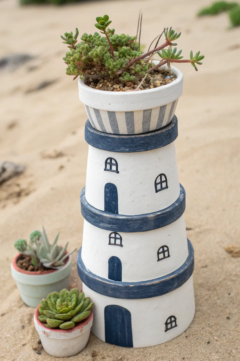 Stacked clay pots become a chic lighthouse planter with coastal stripes and cascading greens