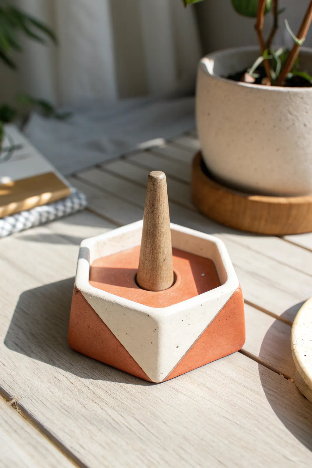 Two-tone geometric clay ring holder with a clean peg post for modern, minimalist storage.