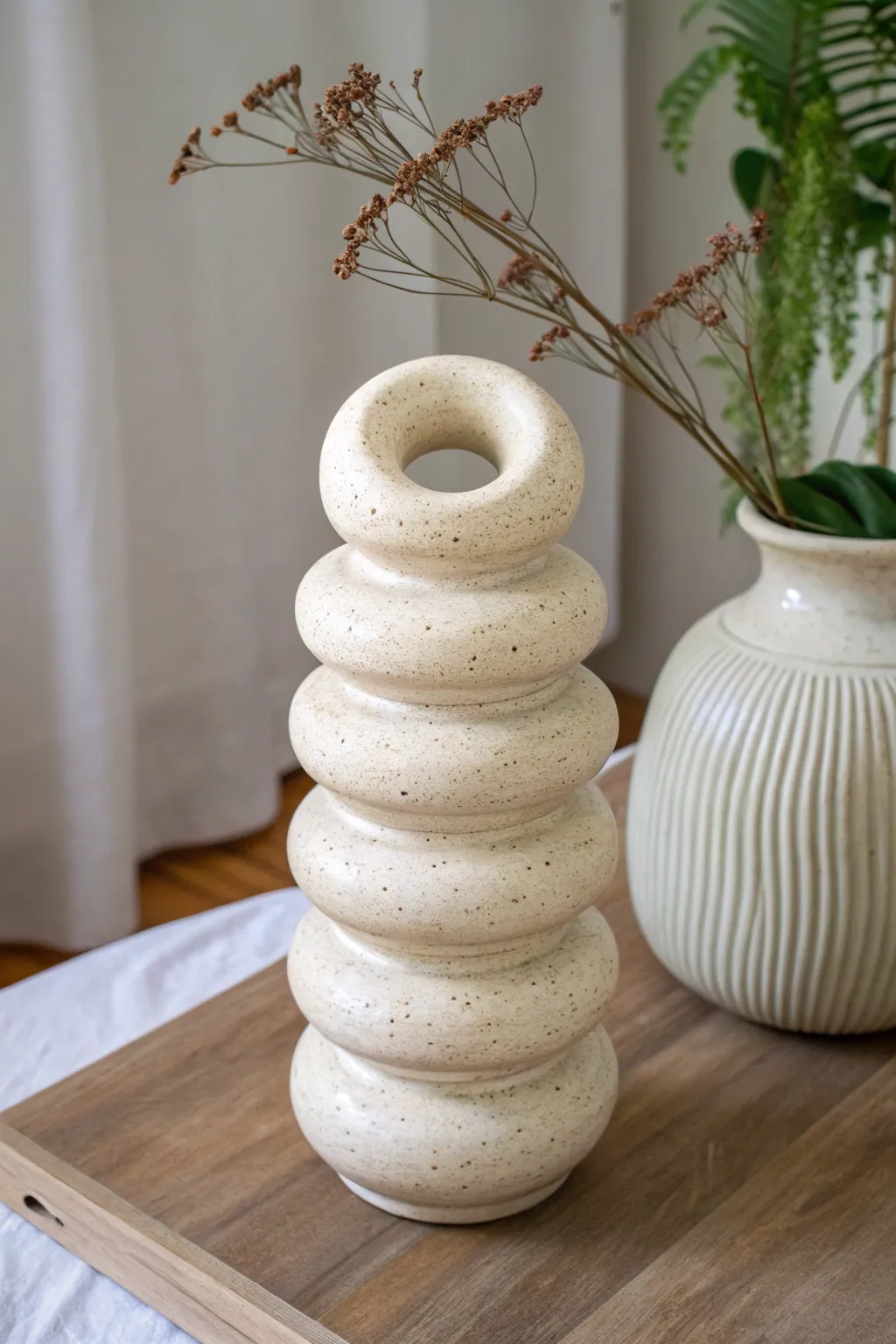 Donut-shaped coil ring vessel with visible bands, minimalist curves, and a wow factor.