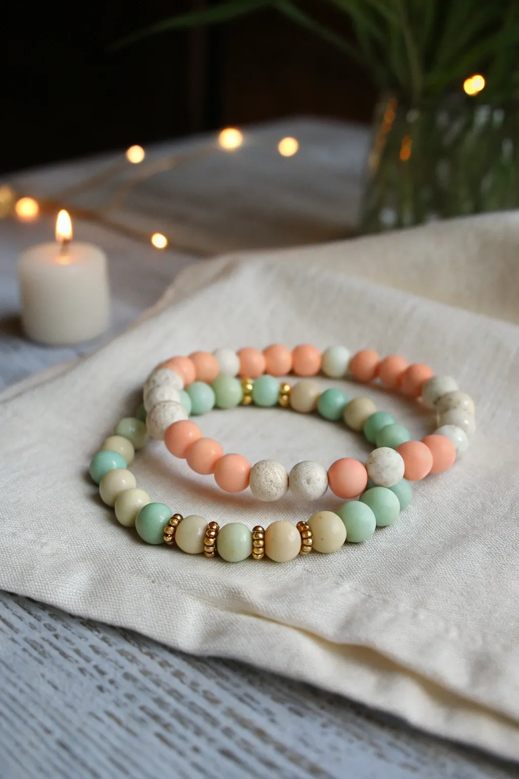 Daytime pastels meet a soft glow for the sweetest night stack of cute clay bead bracelets