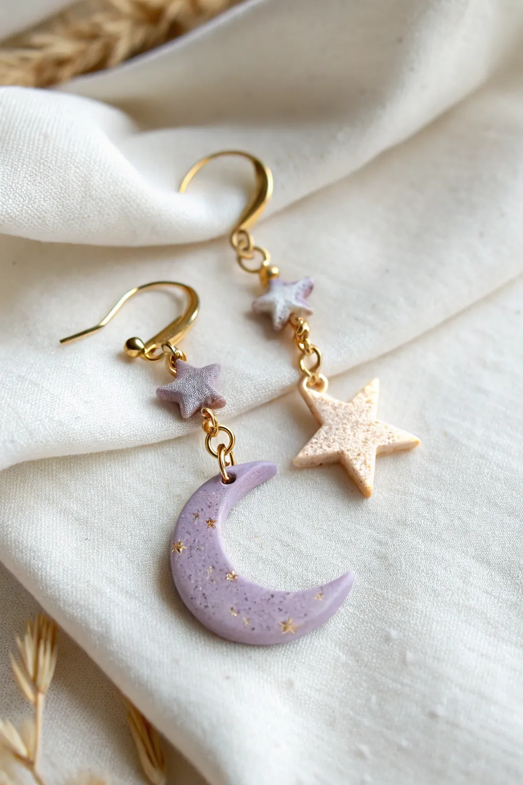Dreamy pastel moon-and-star clay dangler with soft lavender and pale gold sparkle