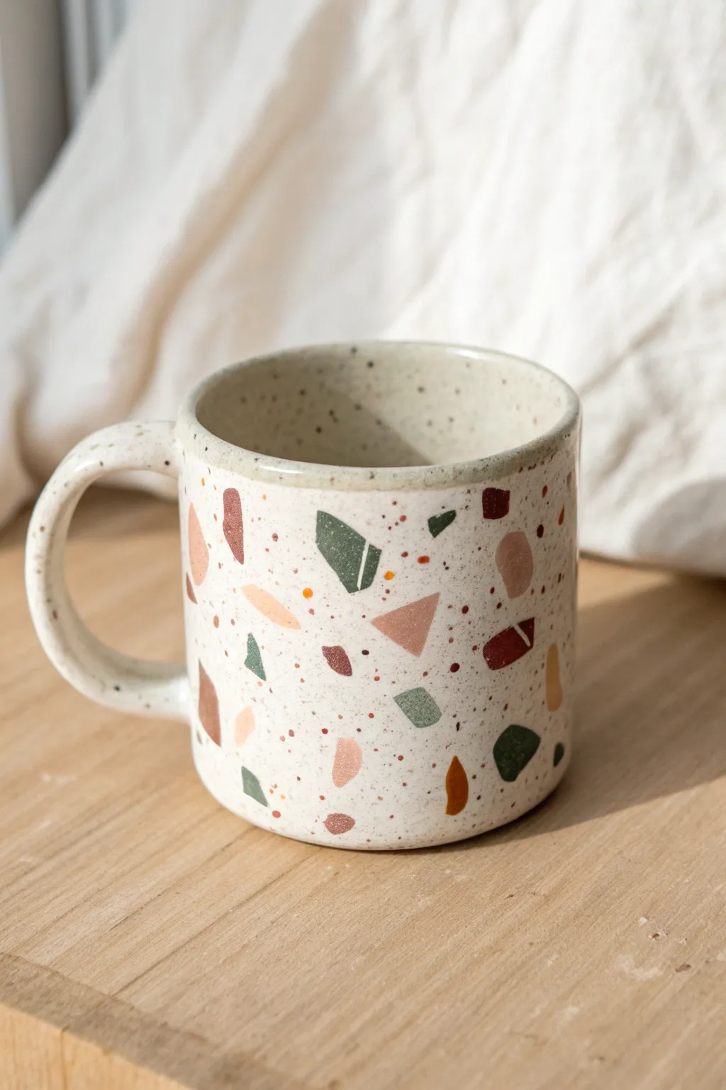 Minimal terrazzo chip mug in muted tones with an asymmetrical modern twist