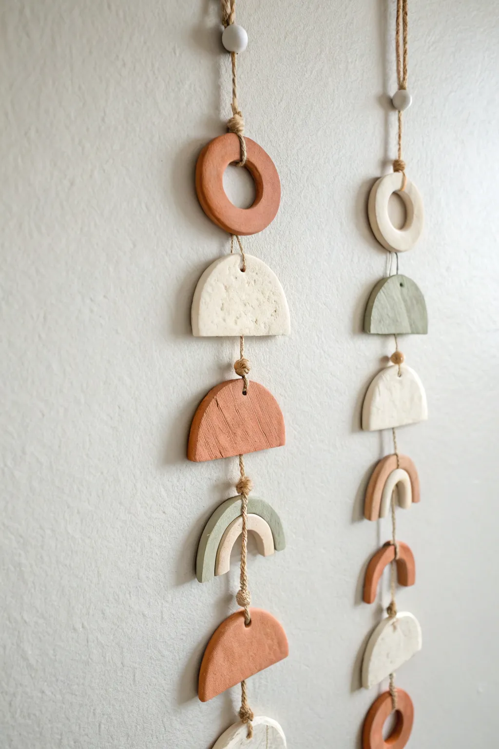 Soft earthy air dry clay charm garland for a simple, cozy boho-minimal wall moment