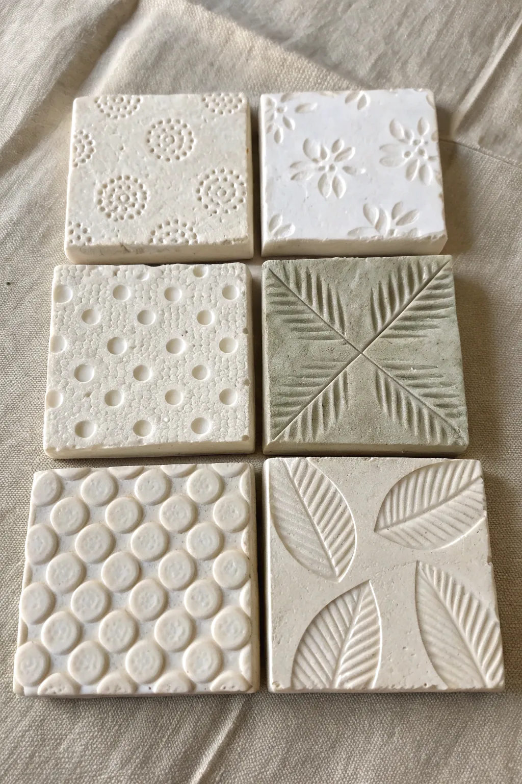 Easy stamped air dry clay tiles for kids, simple textures that pop with a soft paint wash.