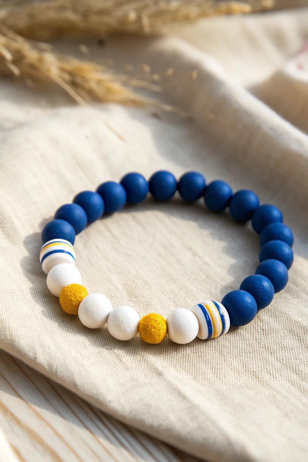 Minimalist team-color clay bead bracelet in bold contrast, styled for a clean Scandinavian look