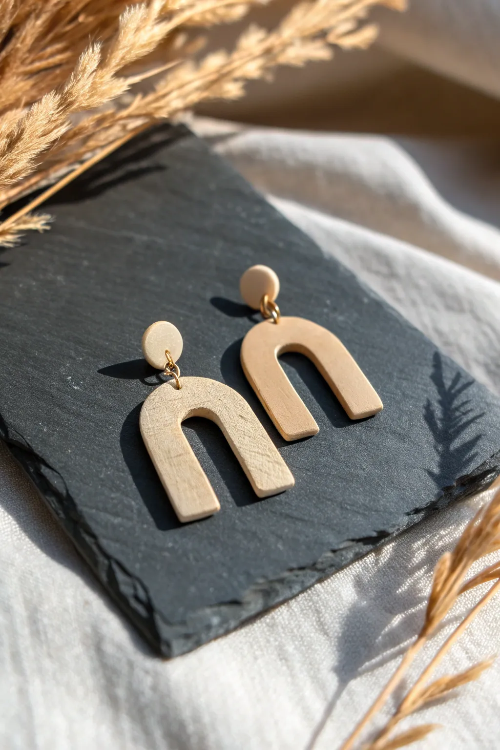 Minimalist arch clay earring with bold negative-space cutout for modern DIY style.