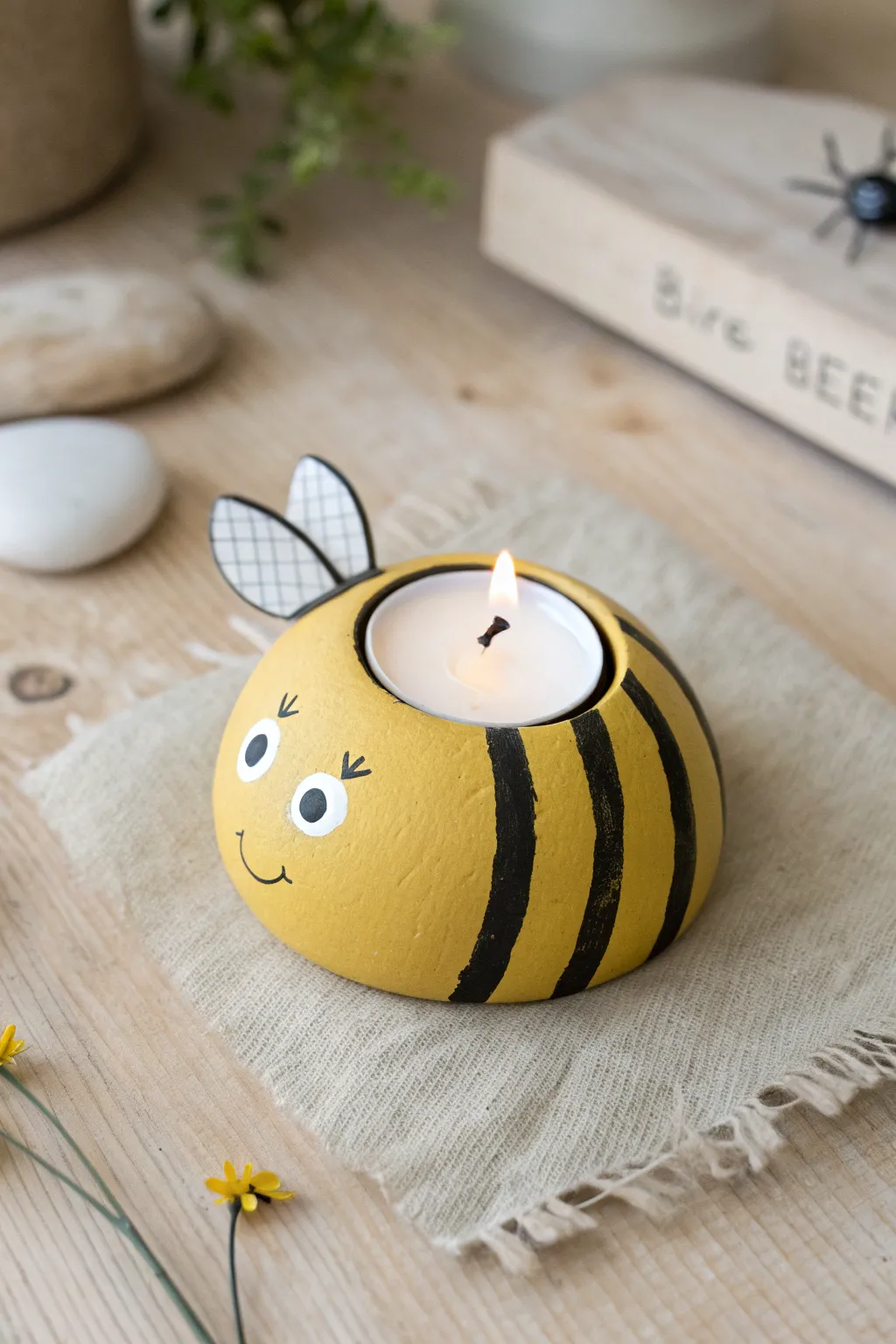 Chubby bee air dry clay tea light holder in sunny yellow and black, minimal boho styling.