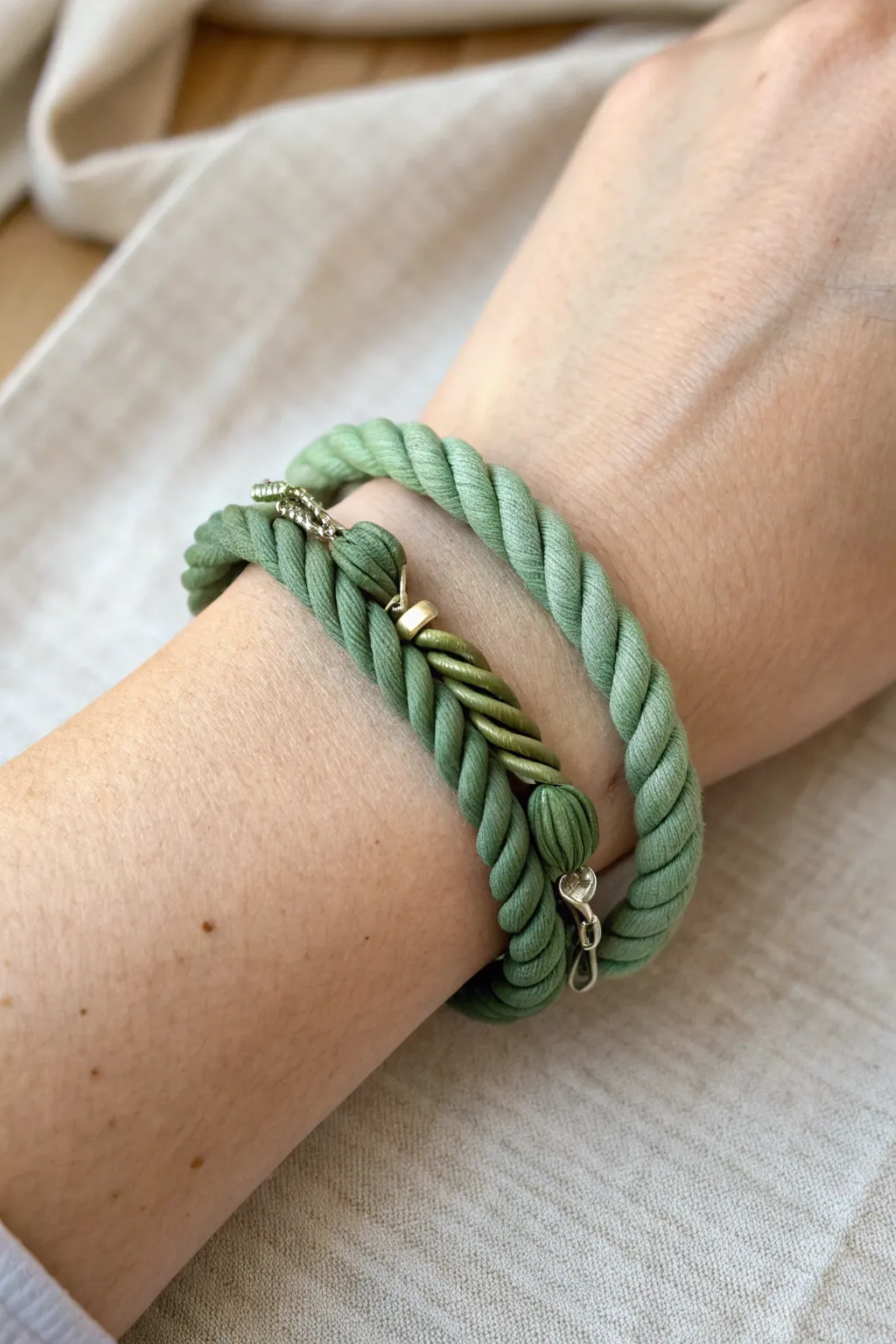 Two-tone green twist clay bracelet on wrist, minimalist Scandinavian vibe with a gentle boho touch.