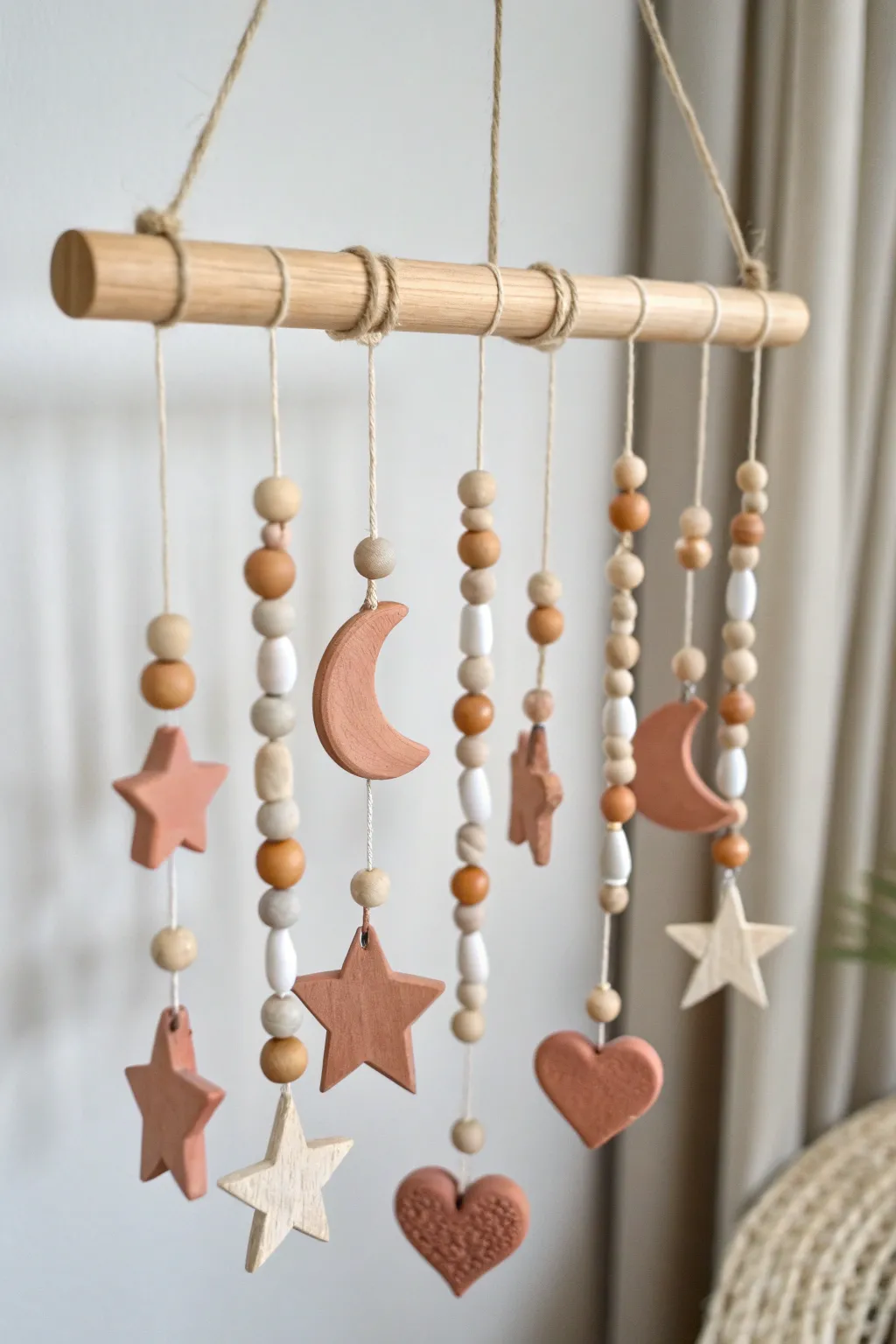Simple air-dry clay mobile with stars, moons, and hearts in soft Scandinavian boho style