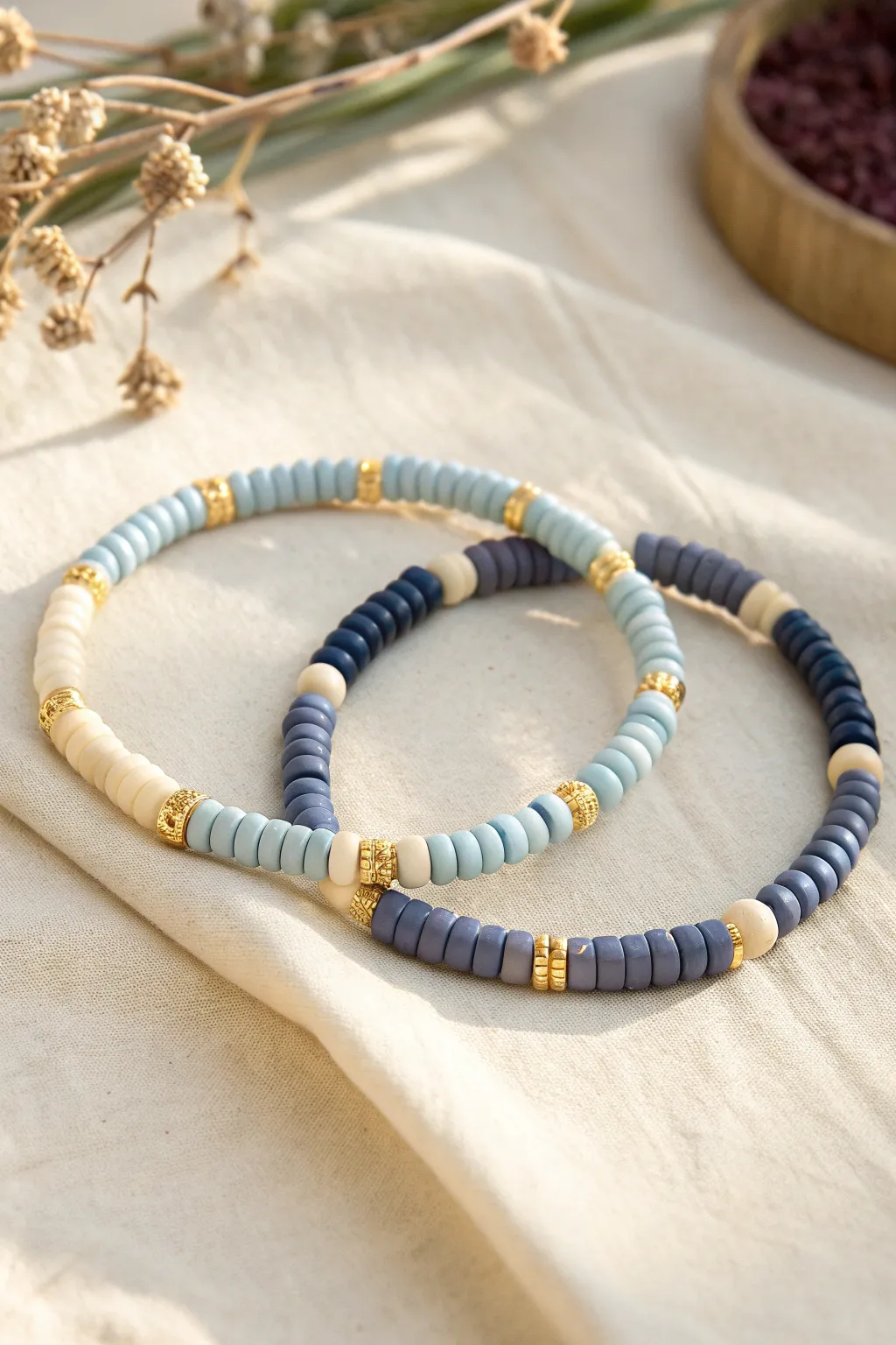 Day-and-night heishi bead bracelets in matching patterns, soft pastels vs deep tones