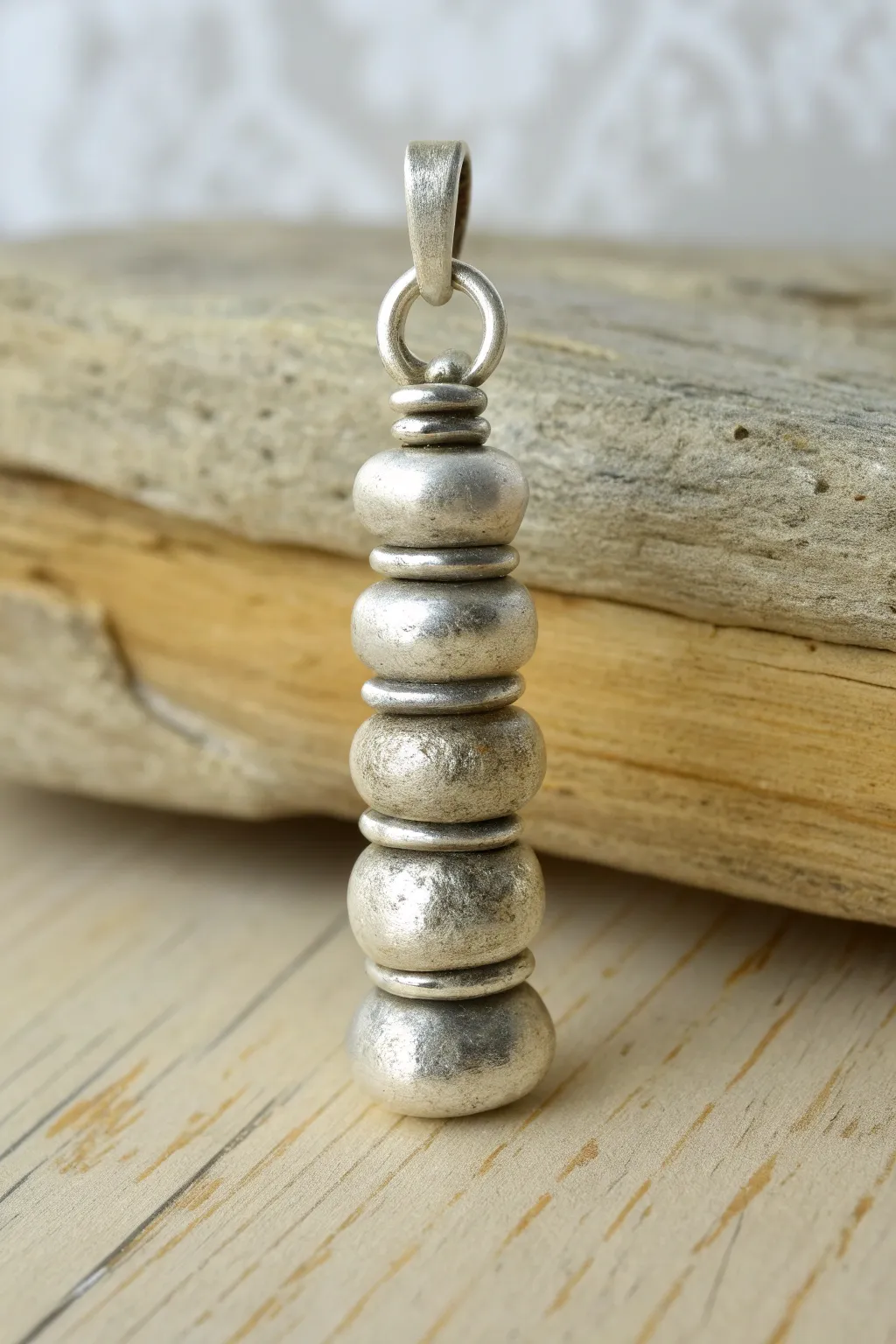 Tiny sculpted metal clay totem pendant with soft patina, minimalist boho elegance.