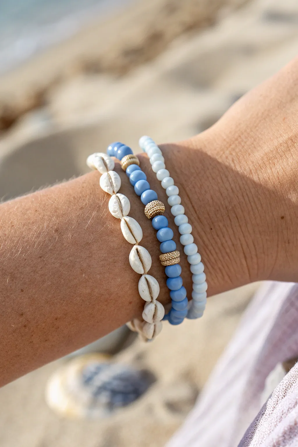Blue and white clay bead stack with tiny seashell spacers for an effortless coastal look