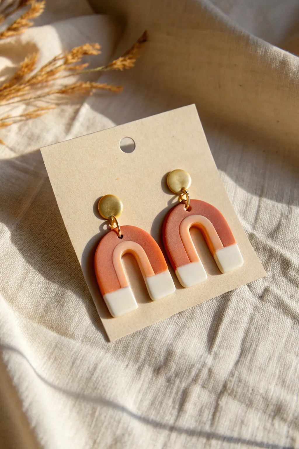 Sunset ombre slab earrings in orange to cream, styled on linen for a minimal boho look.
