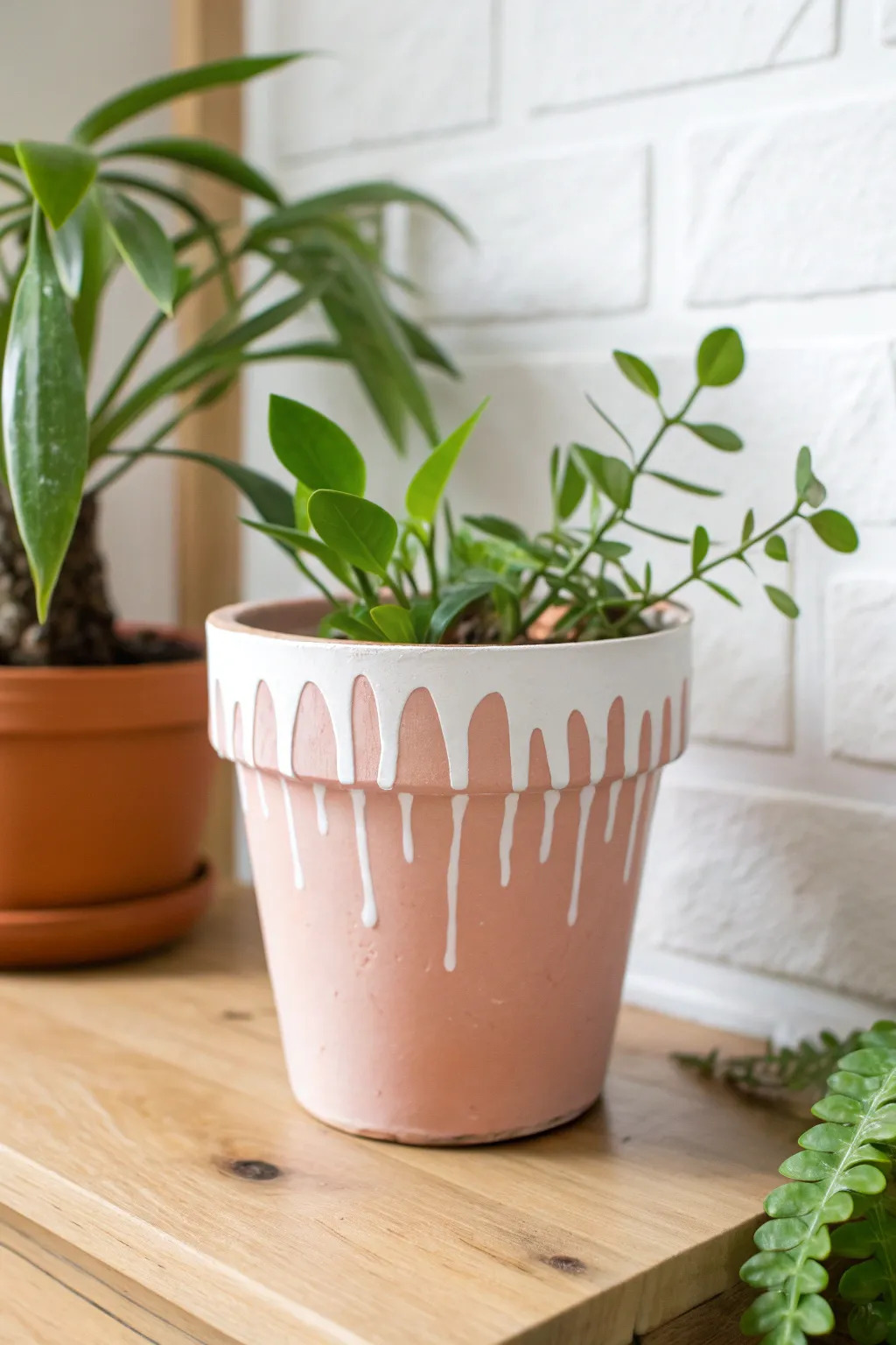 DIY drippy rim flower pot in blush floral tones with a bright green plant, minimalist boho.