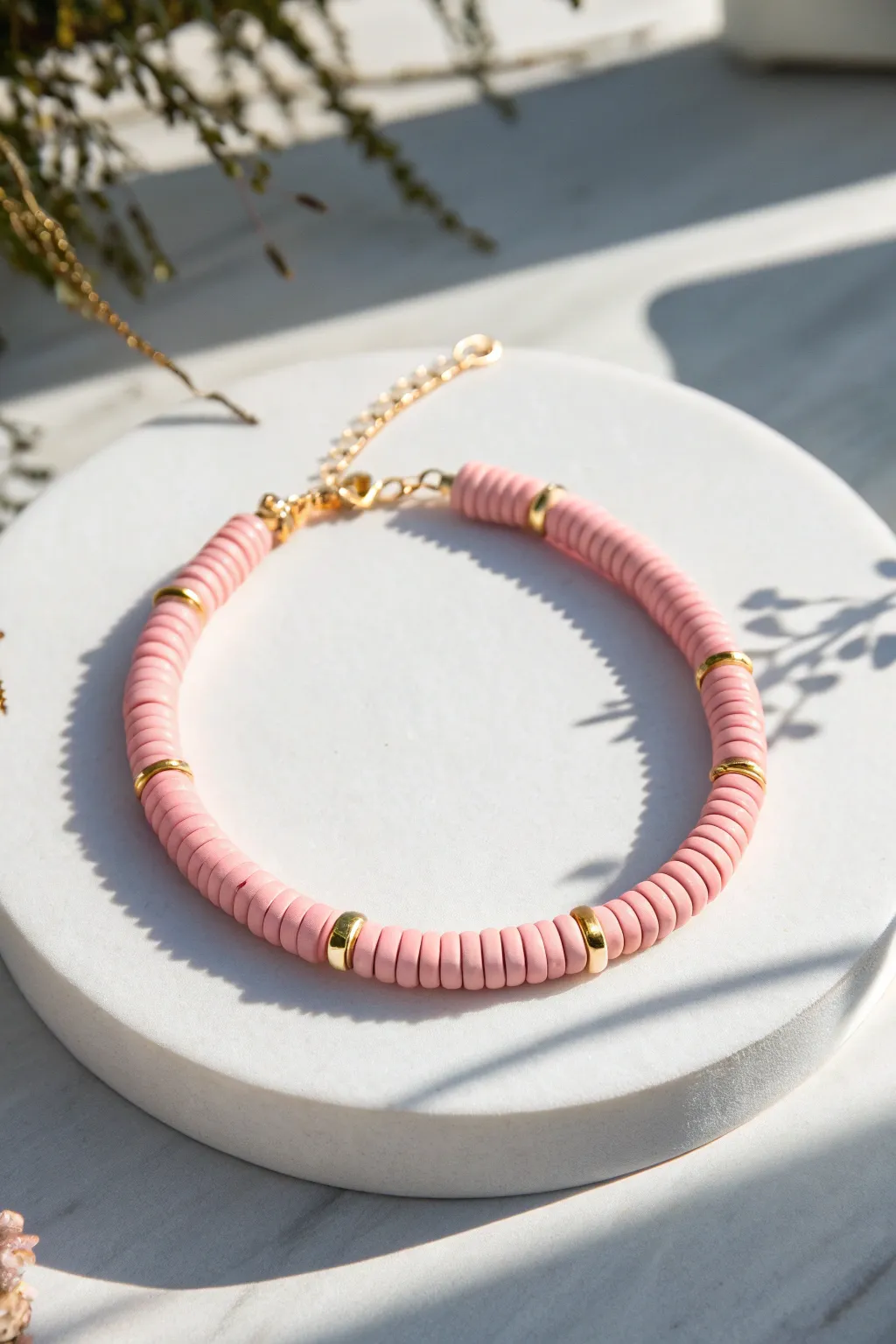 Pink heishi clay bracelet with a chic gold chain accent for an effortless preppy look