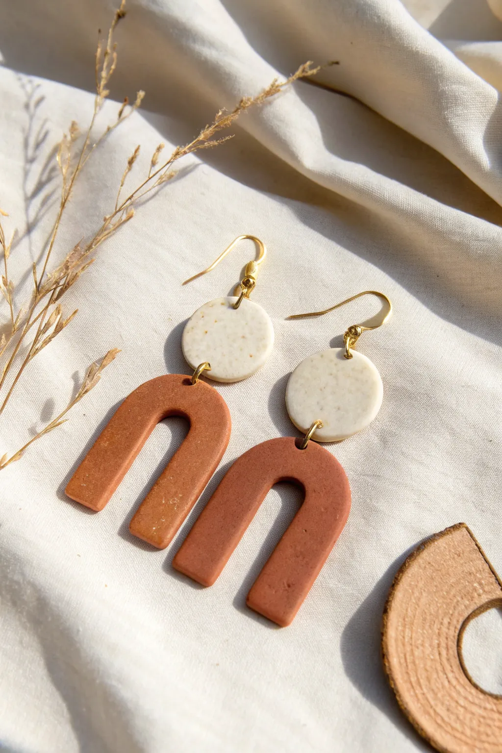 Minimal clay dangles with bold negative-space cutouts for an airy, modern statement