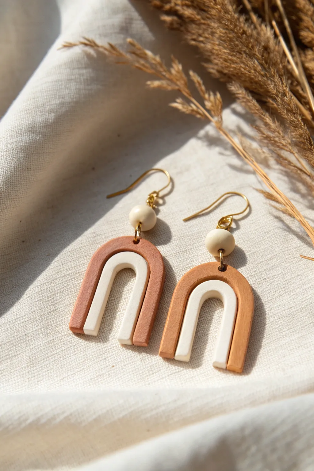 Minimal negative-space arch earrings in soft neutrals, a simple beginner-friendly clay design