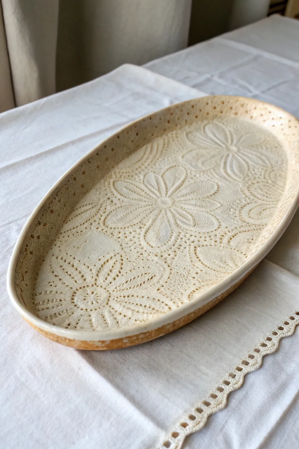 Lace-impressed platter with a softly breaking glaze, minimal styling, and beautifully tactile texture.