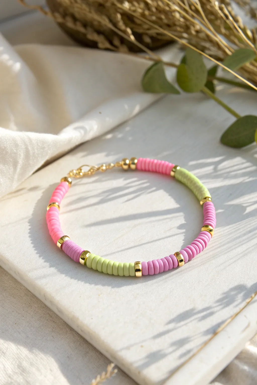 Half-and-half heishi bracelet with pastel meets neon and a tiny gold spacer center detail