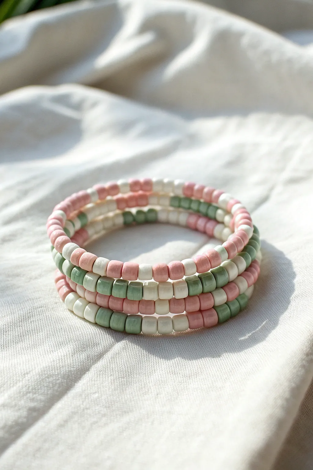 Preppy gingham vibes in pink and green: a cute clay bracelet stack with crisp contrast.