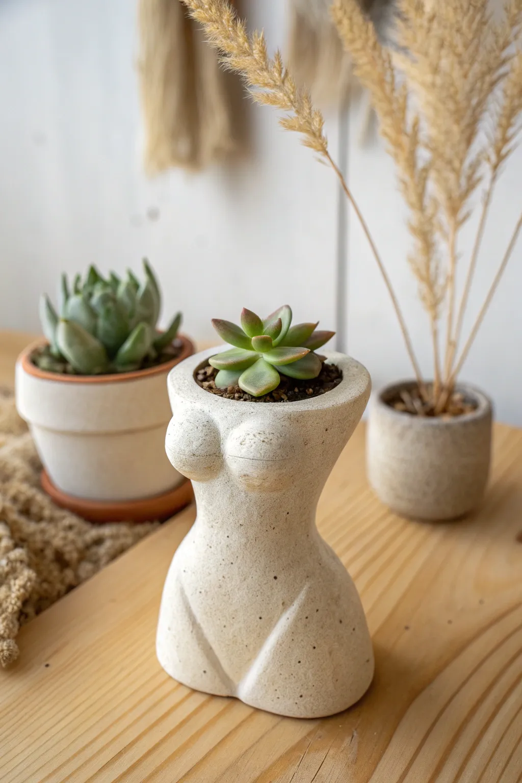 Simple body-form clay planter with a soft neutral glaze, styled with a petite succulent.