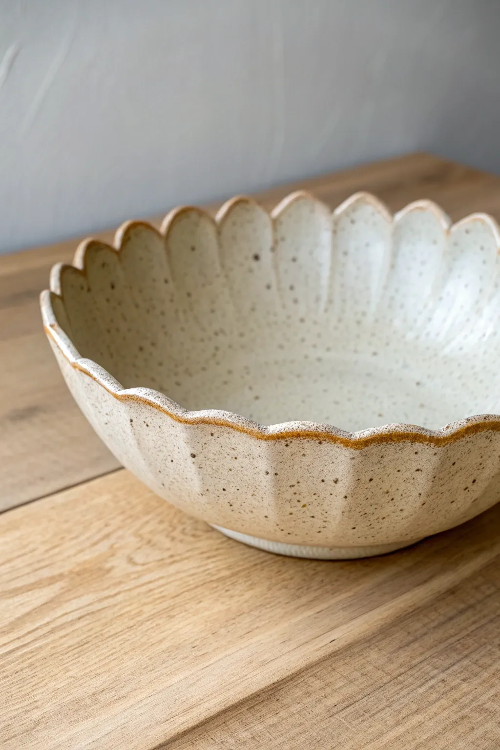 Soft leaf-edge slab bowl in speckled stoneware, a simple boho rim with Scandinavian calm.