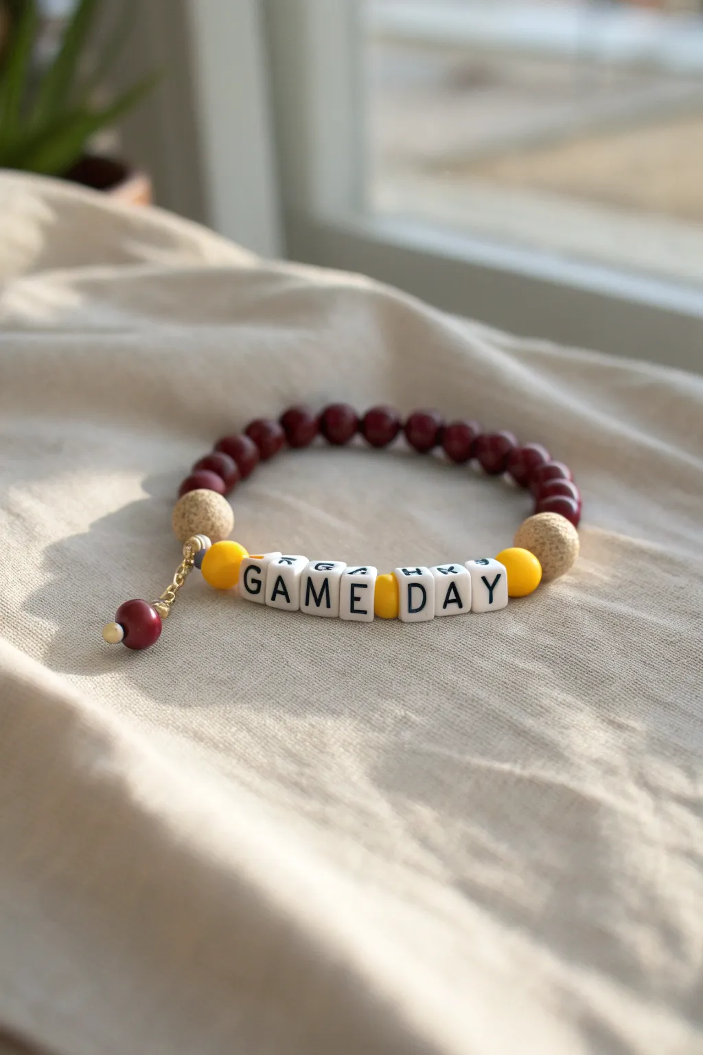 Minimal softball bracelet with bold clay beads and a tiny softball charm, ready for game day