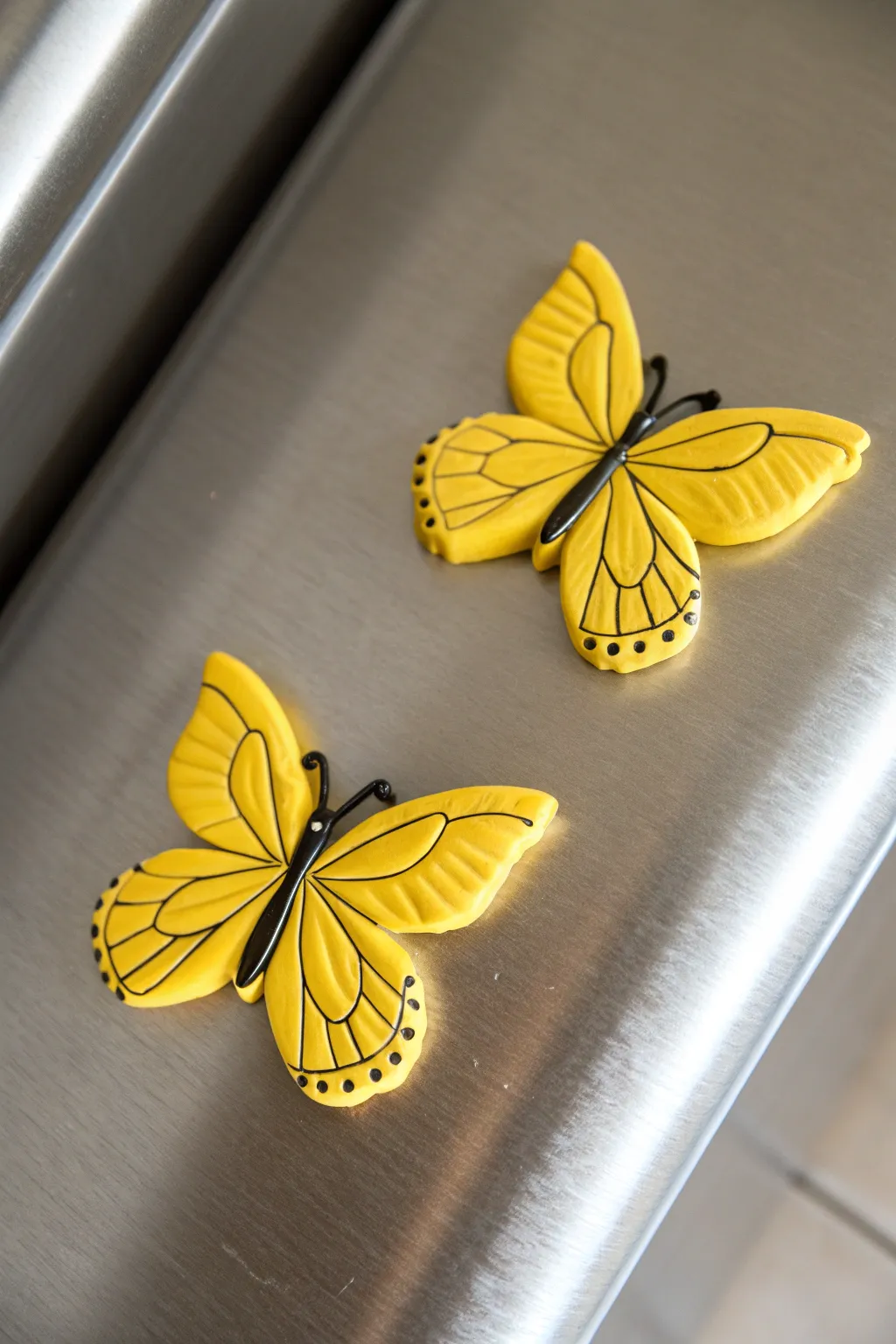 Bright yellow butterfly clay magnets on cool metal, minimalist and cheerful with handmade charm