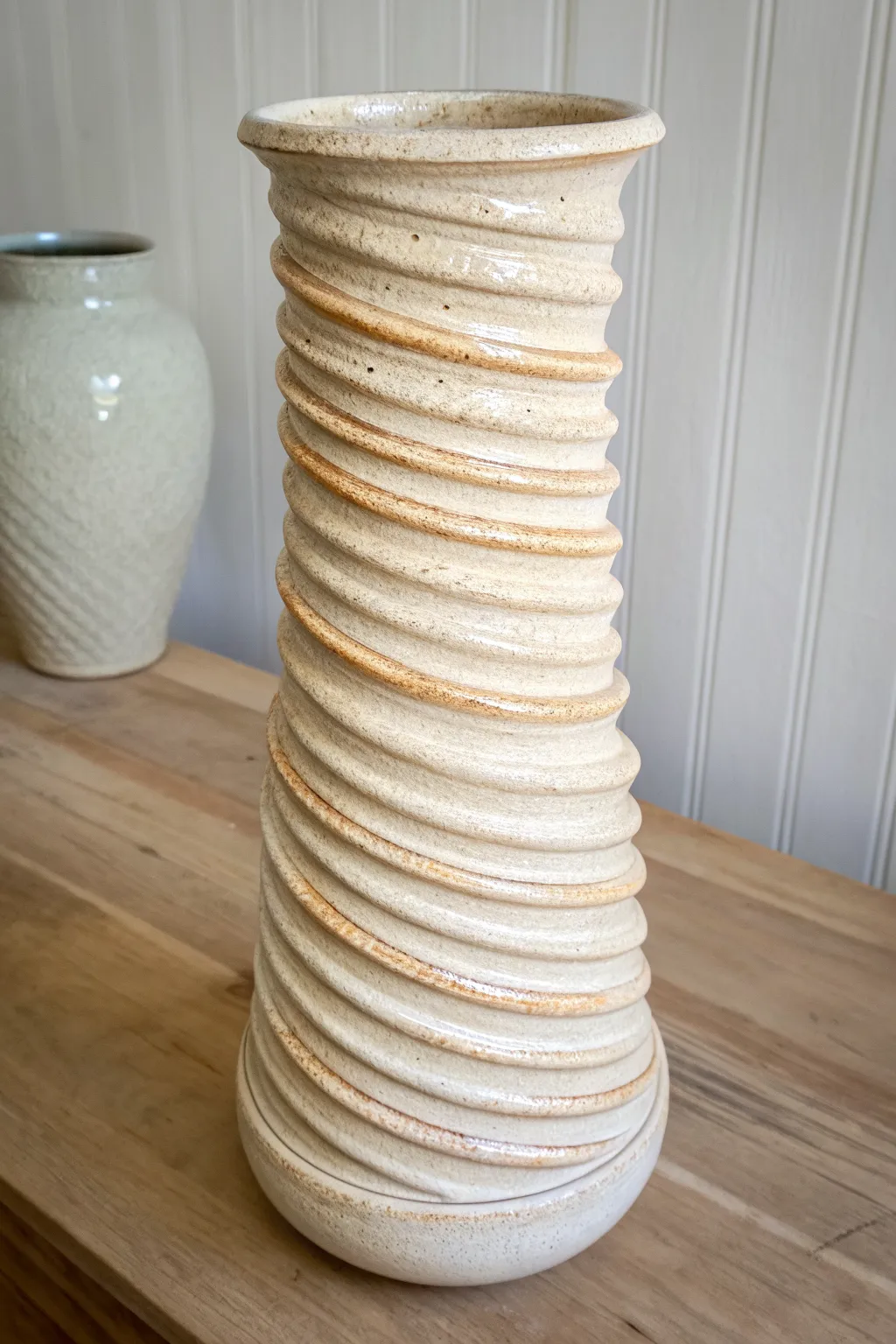 Soft-toned coil drip column sculpture, minimal Scandinavian lines with a hint of boho warmth.