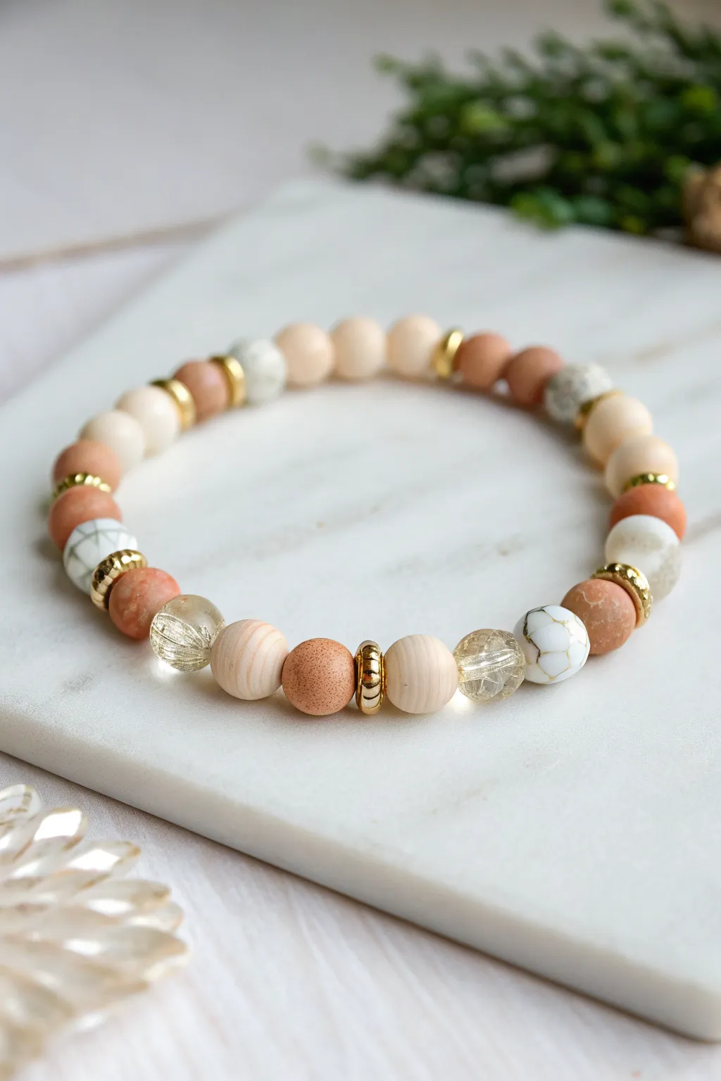 Matte heishi beads meet glossy transparent accents and gold spacers for effortless boho minimalism.