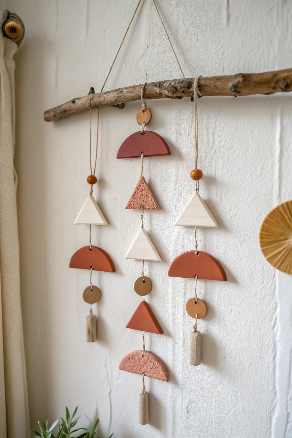 Asymmetrical air dry clay mobile with mixed shapes for a modern, minimalist boho wall
