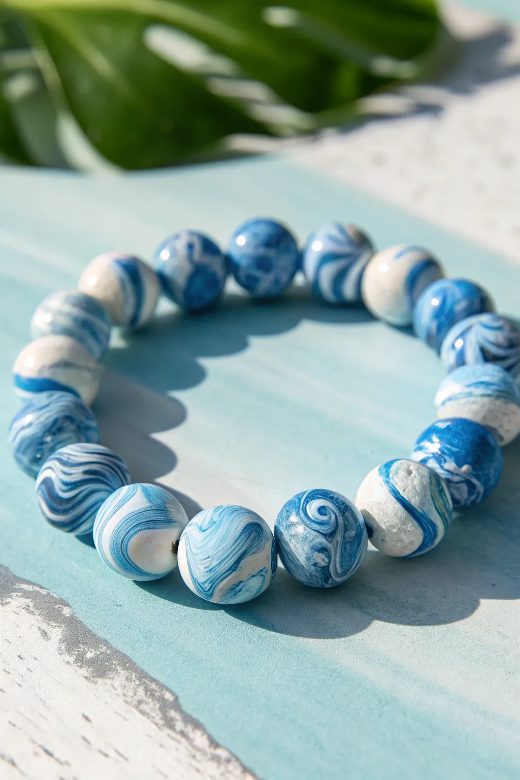 Marbled blue-and-white clay beads swirl like sea foam in a bold, beachy statement bracelet.