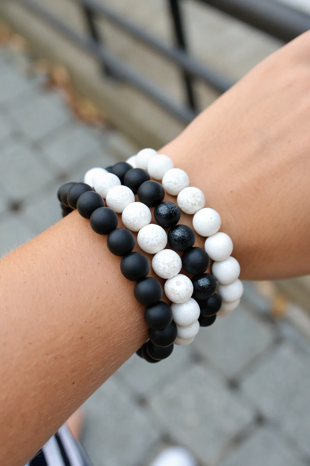 Three black-and-white clay bead bracelets stacked for a clean, modern monochrome look.