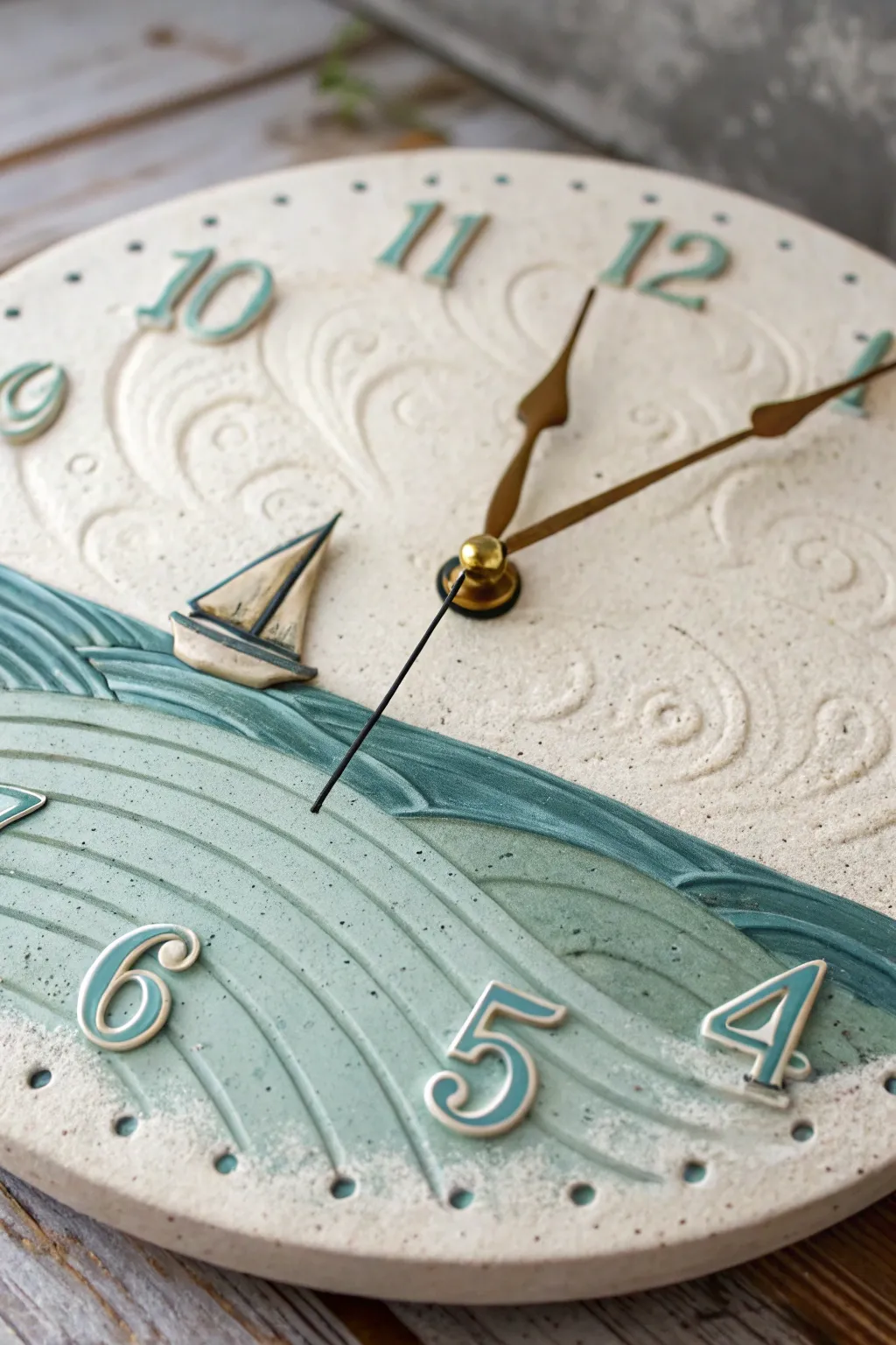 Seascape relief ceramic clock with ocean waves and a tiny sailboat in soothing blue-green glaze