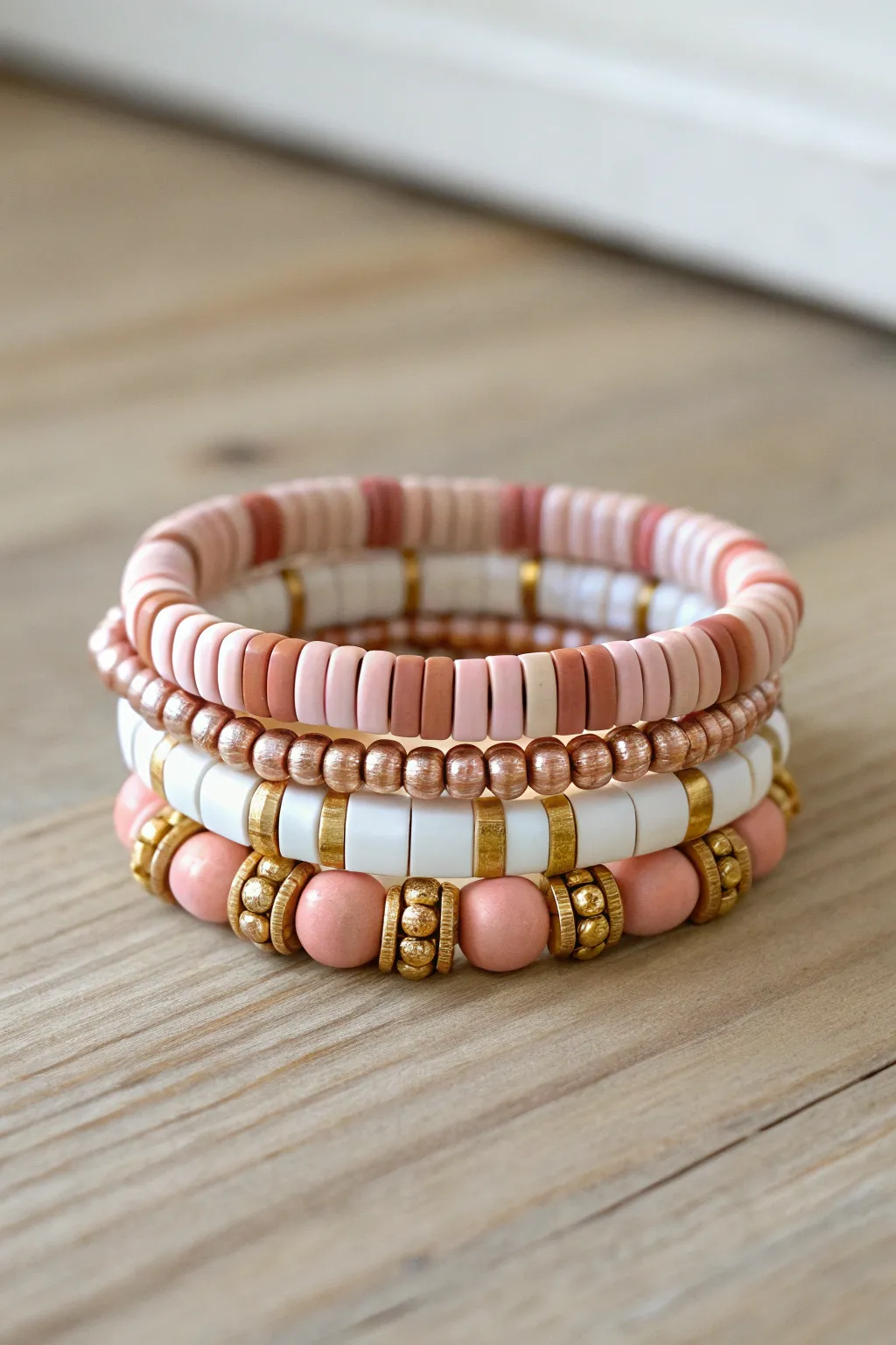 Preppy clay bead bracelet stack in blush, white, and gold for easy mix-and-match style
