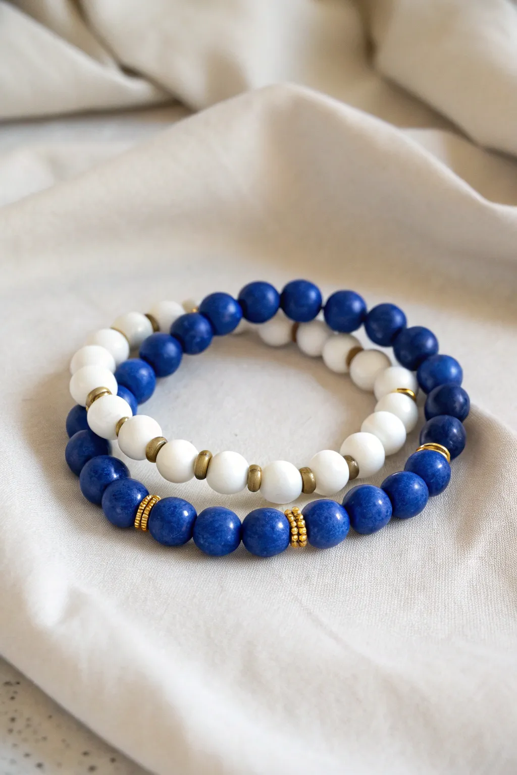 Double-strand blue and white clay bead bracelet stack pair with clean minimalist, boho charm