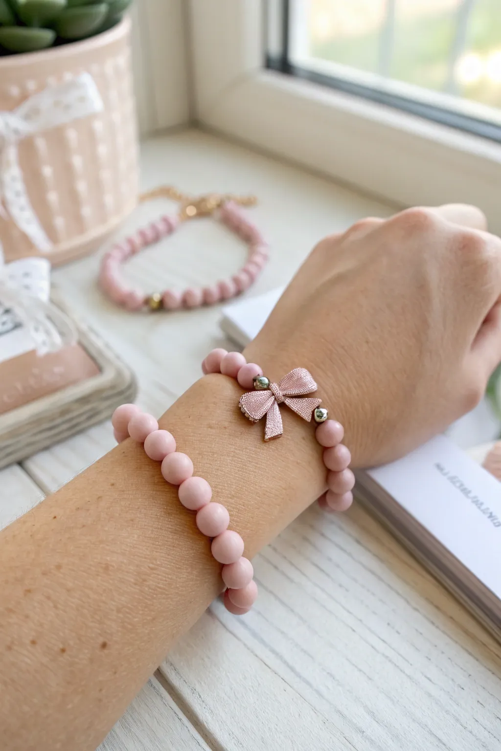 Sweet soft pink clay bead bracelet with a bow center charm, minimalist and boho perfect.