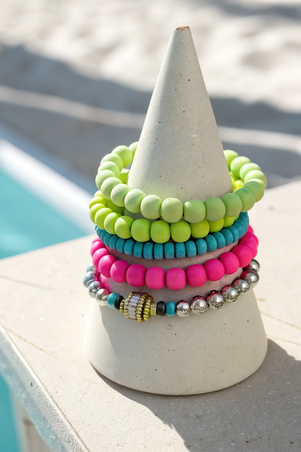 Festival-ready clay bead stack in lime, pink, and aqua with subtle metallic sparkle
